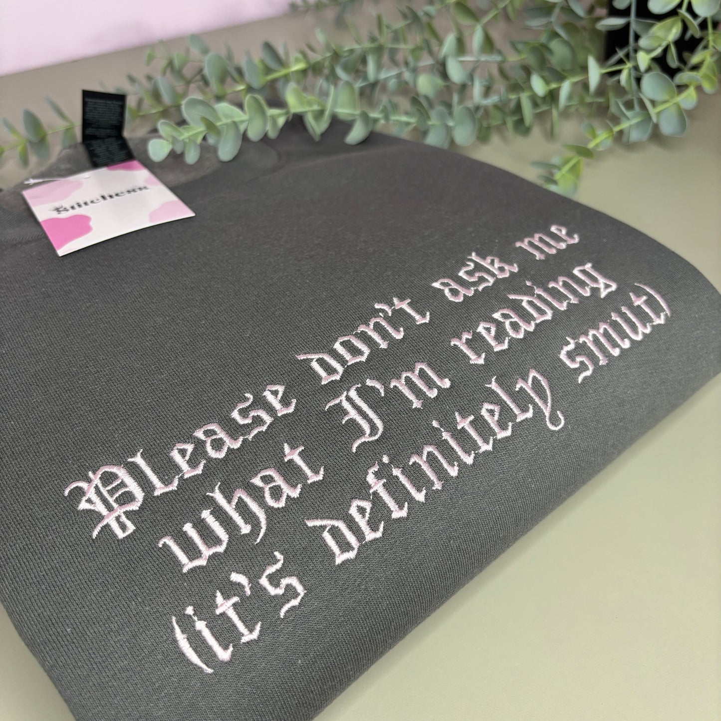DON'T ASK WHAT I'M READING EMBROIDERED SWEATSHIRT