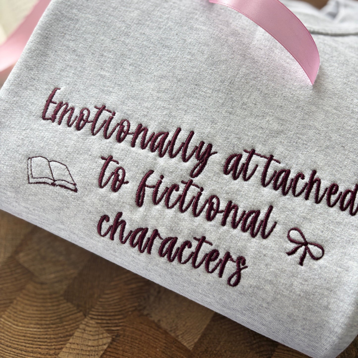 EMOTIONALLY ATTACHED TO FICTIONAL CHARACTERS EMBROIDERED SWEATSHIRT