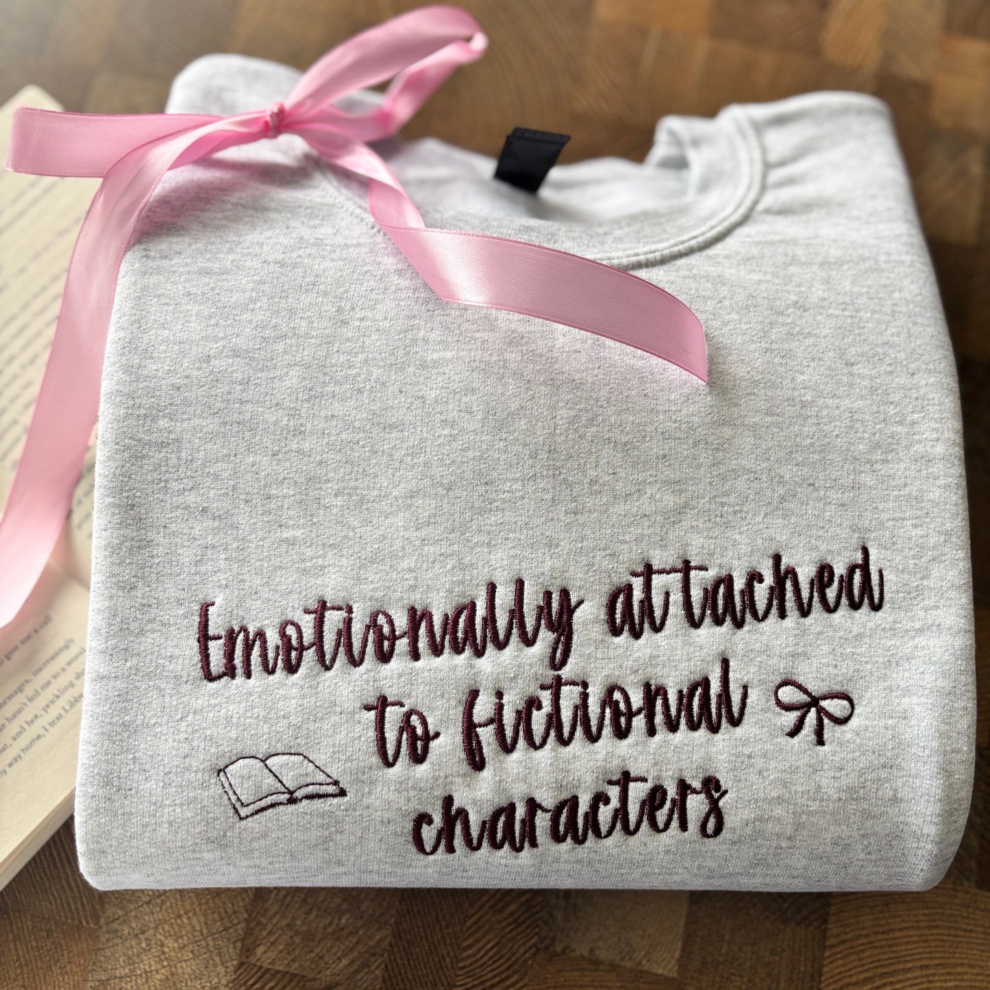 EMOTIONALLY ATTACHED TO FICTIONAL CHARACTERS EMBROIDERED SWEATSHIRT