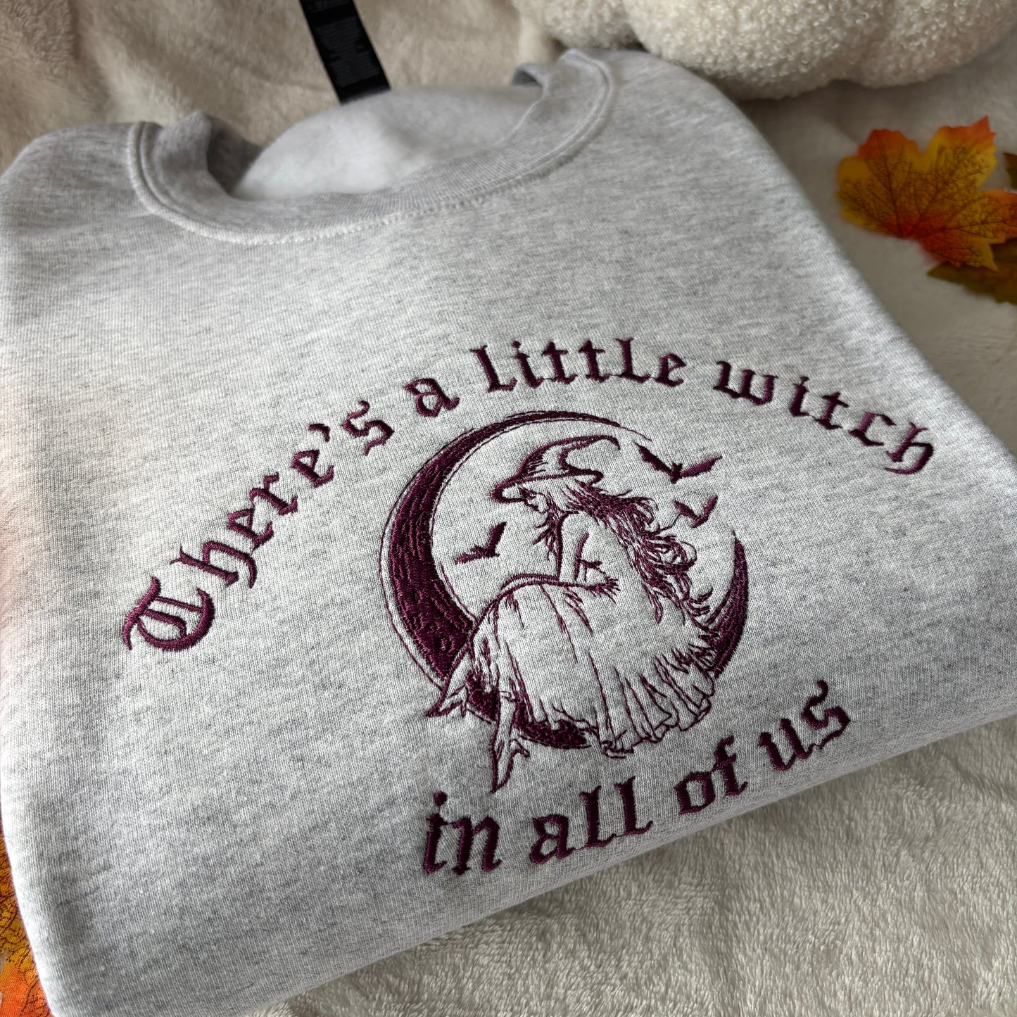 THERE'S A LITTLE WITCH IN ALL OF US EMBROIDERED SWEATSHIRT