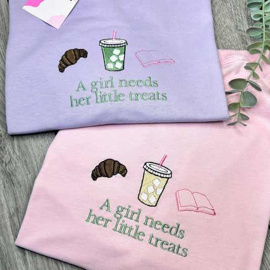 A GIRL NEEDS HER LITTLE TREATS EMBROIDERED SWEATSHIRT