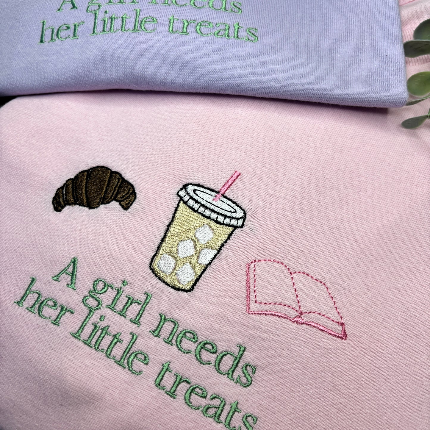 A GIRL NEEDS HER LITTLE TREATS EMBROIDERED SWEATSHIRT