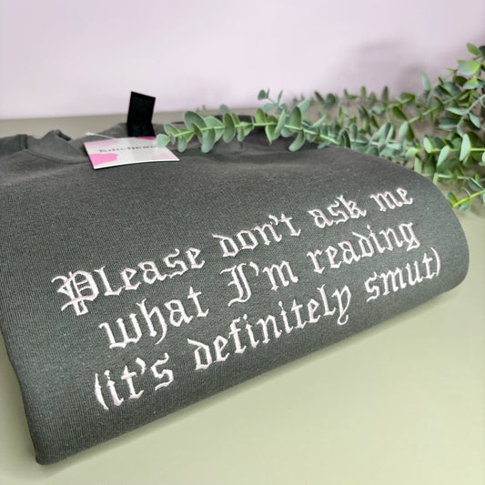DON'T ASK WHAT I'M READING EMBROIDERED SWEATSHIRT