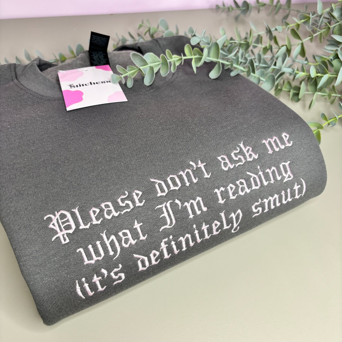 DON'T ASK WHAT I'M READING EMBROIDERED SWEATSHIRT
