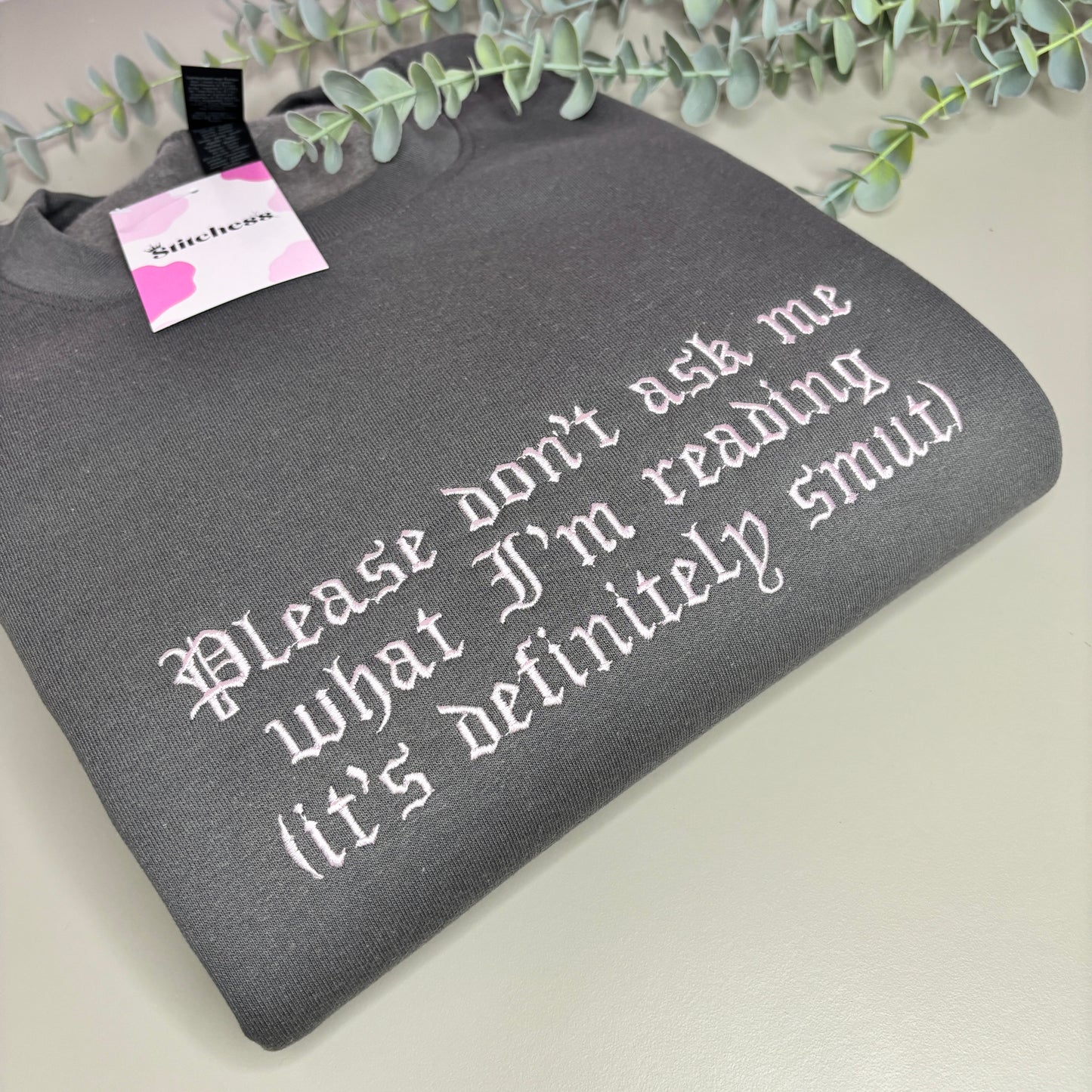 DON'T ASK WHAT I'M READING EMBROIDERED SWEATSHIRT