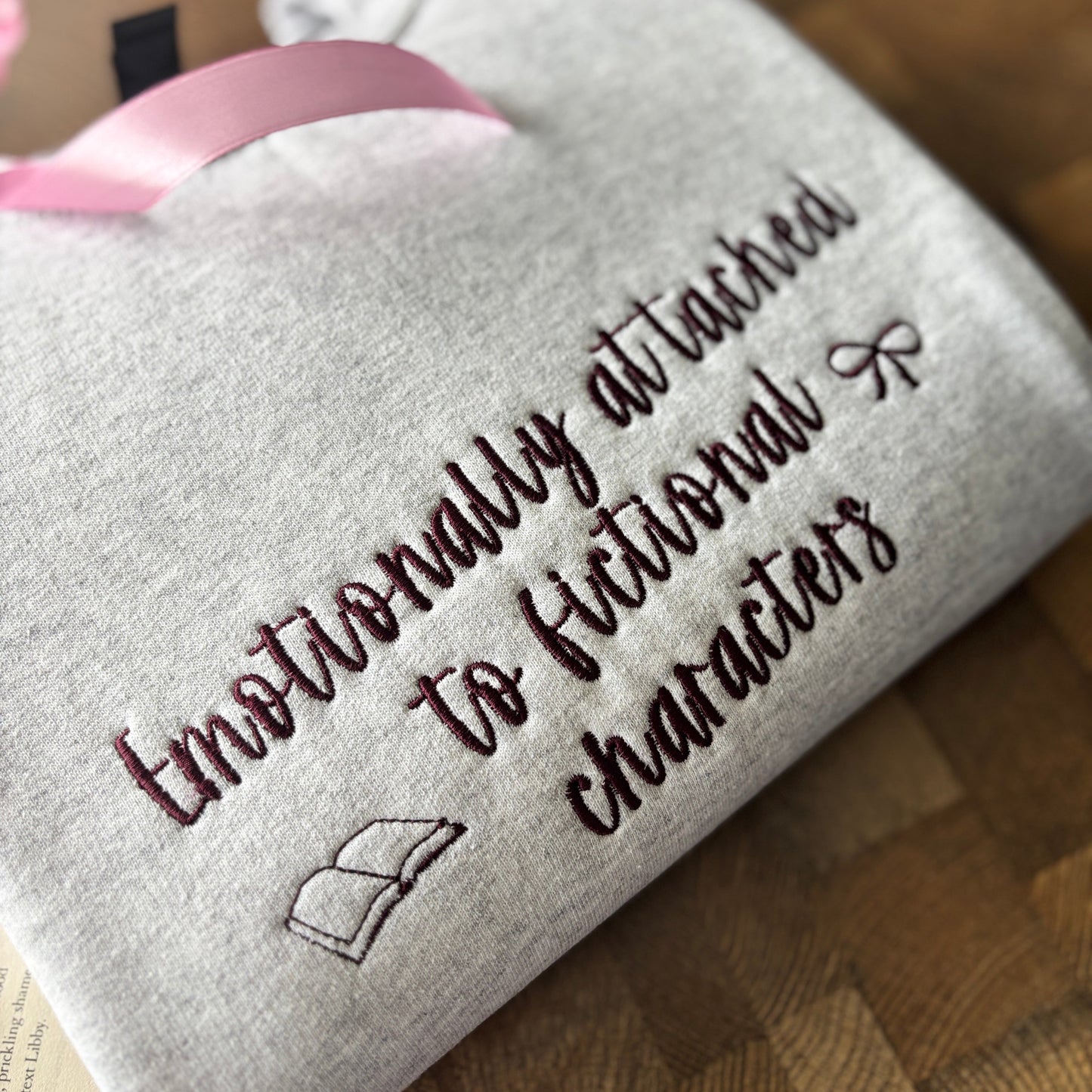 EMOTIONALLY ATTACHED TO FICTIONAL CHARACTERS EMBROIDERED SWEATSHIRT