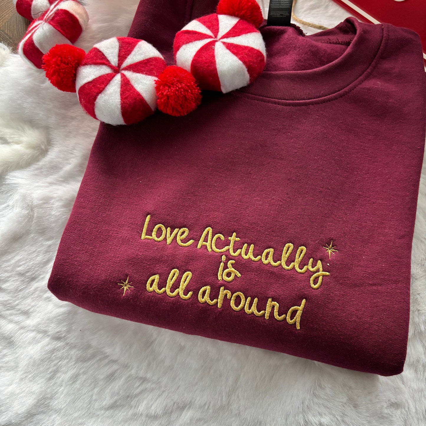 LOVE ACTUALLY IS ALL AROUND EMBROIDERED SWEATSHIRT