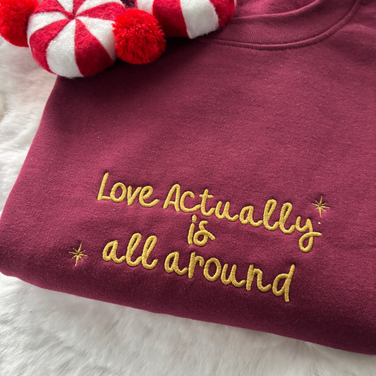 LOVE ACTUALLY IS ALL AROUND EMBROIDERED SWEATSHIRT