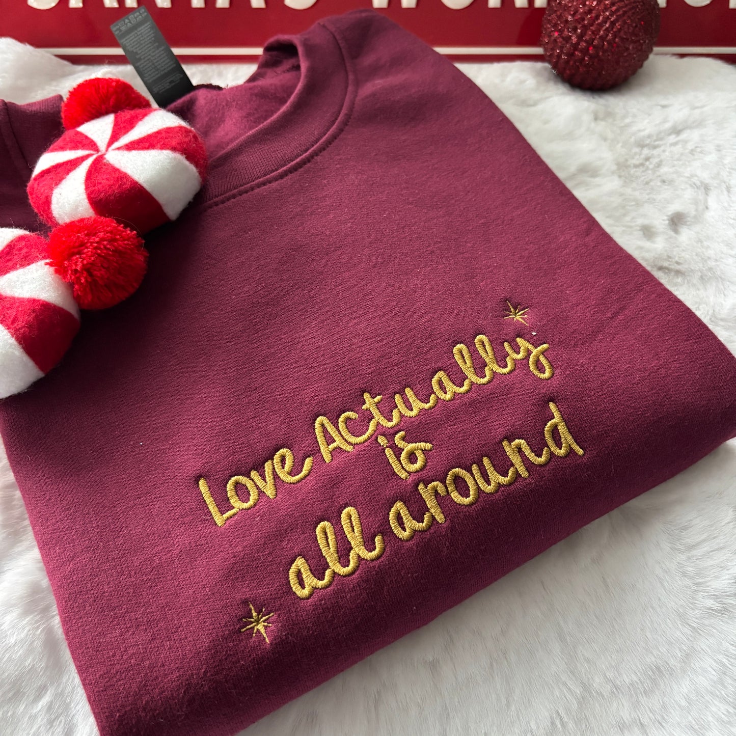 LOVE ACTUALLY IS ALL AROUND EMBROIDERED SWEATSHIRT